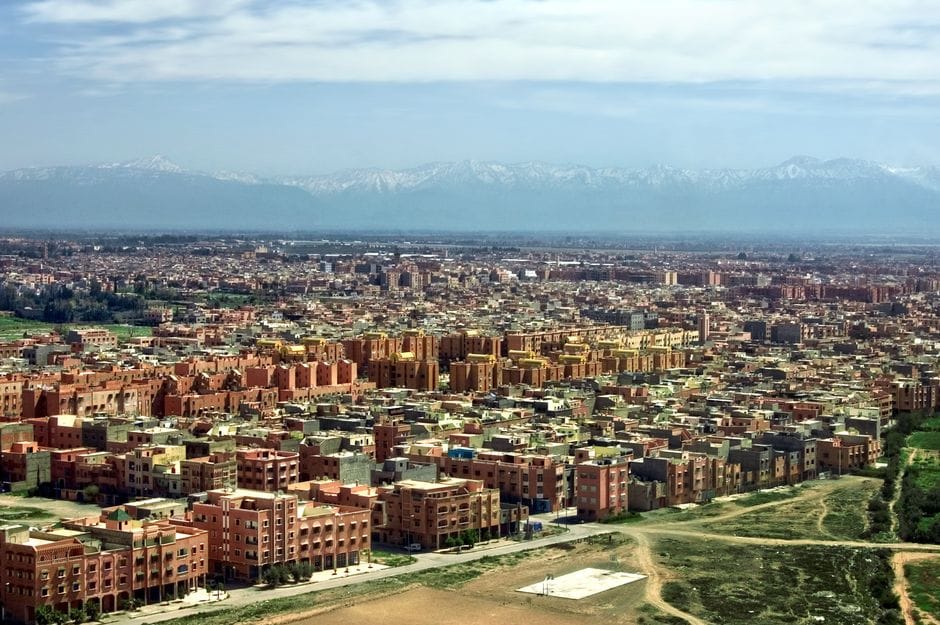 Aerial view of Marrakech rooftops with the Atlas mountains behind